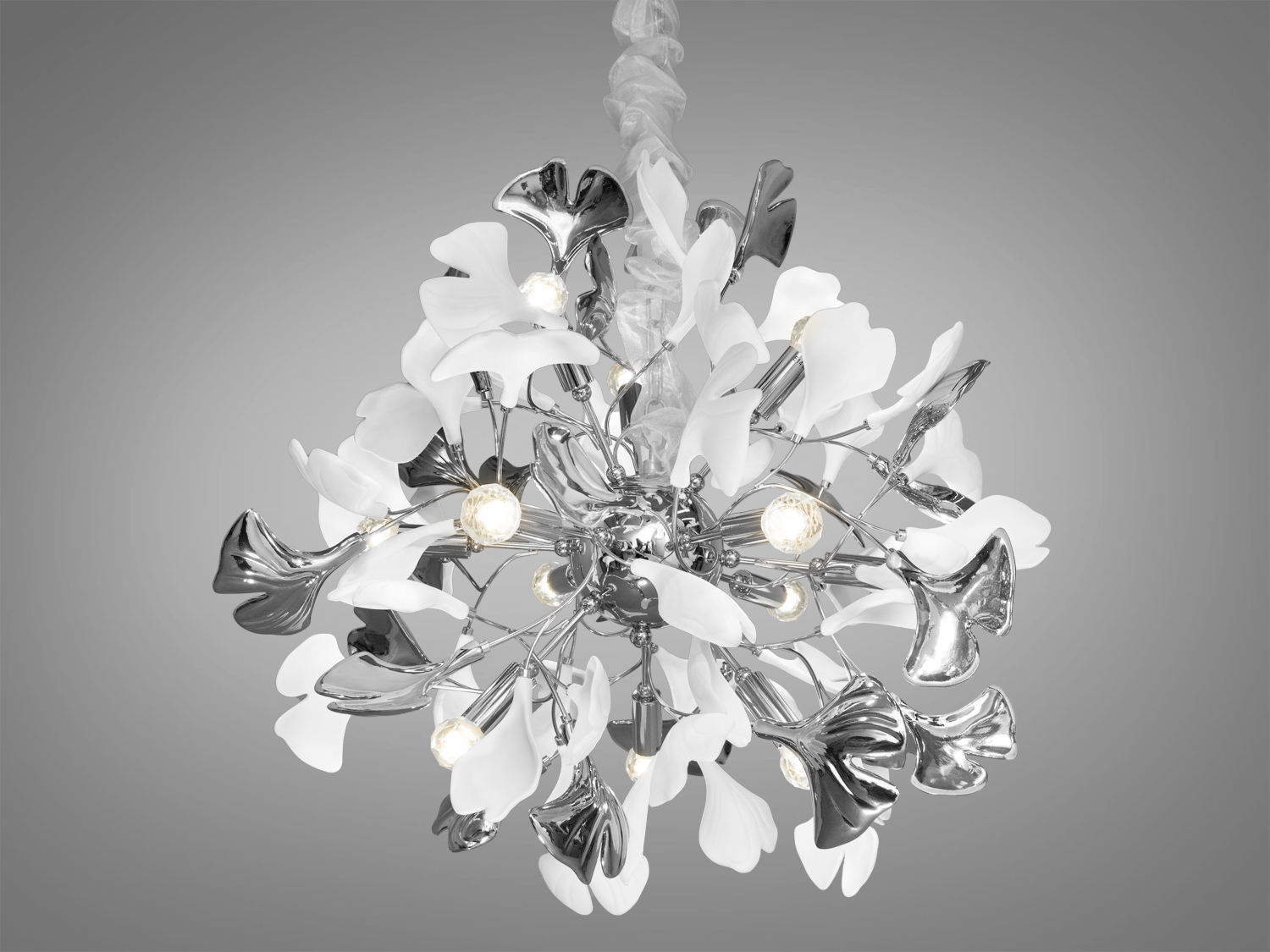 Ця люстра з фарфоровими елементами&nbsp;є втіленням вишуканості та дизайнерської думки, в якій вдало поєднуються ехо давньої мудрості та сучасні тенденції інтер'єрного мистецтва. Міцний металевий каркас керамічної люстри модерн, який служить основою для ніжних керамічних пелюсток, оформлених у формі листя Гінкго Білоба, робить цю люстру не лише міцною та довговічною, а й наповнює її символікою довголіття та непереможної краси.
Якщо ви хочете купити люстри гуртом від ТМ &laquo;Діаша&raquo;, наші менеджери завжди готові надати професійну консультацію та підтримку.
Неглазуровані білі пелюстки з фарфору-бісквіту, які нагадують мармур античних палаців, додають інтер'єру відчуття стабільності та історичної глибини. Вони втілюють спокій та розслаблення, створюючи ефект природної гармонії в будь-якому просторі, де вони з'являються.
Хромовані пелюстки з глазур'ю під металік додають сучасних акцентів, створюючи розкішний блиск, який ідеально гармонує зі світлом лампи E14. Ця гра світла та тіні вносить в інтер'єр атмосферу унікальності та витонченості.
Регульована висота люстри дозволяє ідеально адаптувати її розміщення залежно від потреб простору, забезпечуючи оптимальне освітлення і затишок у вашому домі. Люстра стане центральним елементом декору, додавши інтер'єру стиль, елегантність та чарівність.
Люстра в вітальню створить особливу атмосферу для прийому гостей, де кожна деталь відіграє роль у створенні загального враження. Люстра в кабінет допоможе створити середовище концентрації та інтелектуального праці, де кожен предмет відіграє свою функціональну роль.
У великому залі ця люстра стане справжнім виразом розкоші та гостинності, а в кухні допоможе поєднати практичність із сучасним дизайном, додаючи простору яскравість та оригінальність. Для тих, хто шукає купити люстру в спальню, ця модель забезпечить ідеальне освітлення для релаксації та відпочинку.
Купити люстру недорого можна в Епіцентрі, де представлений широкий вибір освітлювальних рішень для будь-якого смаку та бюджету. Для жителів Харкова купівля цієї люстри виявиться простою та зручною, адже місто пропонує чудові можливості для шанувальників дизайнерських новинок від ТМ &laquo;Діаша&raquo;.
Цей світильник ідеально підходить для інтер'єрів, де цінується симбіоз класики та модерну, де традиційні форми поєднуються з сучасними матеріалами, створюючи новітній вигляд класичних просторів. Він також ідеально впишеться в інтер'єри стилів ар-нуво або ар-деко, де кожен елемент декору відіграє важливу роль у створенні неповторної атмосфери приміщення.
Чудовим дизайнерським рішенням, було б придбання всього комплекту із серії &laquo;Гінкго Білоба&raquo;. До нього входять: керамічні люстри круглої форми, керамічні люстри витягнутої форми, керамічні бра, керамічний торшер, керамічний настільний світильник.
Дизайнерська люстра новинка 2024, магнетична люстра з фарфоровими елементами, люстри на 12 лампочок е14, люстри від вітчизняного виробника ТМ 